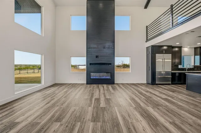 a view of a hallway with wooden floor and a fireplace