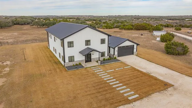 a view of a house with wooden fence