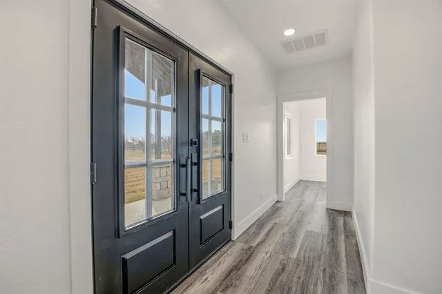 a view of hallway with wooden floor