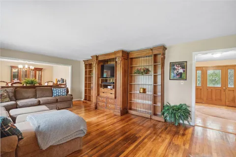 a living room with furniture and wooden floor