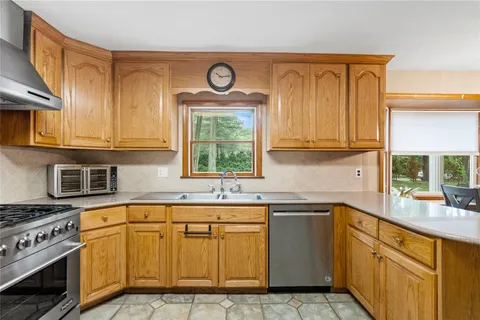 a kitchen with stainless steel appliances granite countertop a sink and cabinets