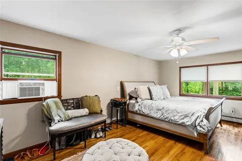 a bedroom with a bed couch and window