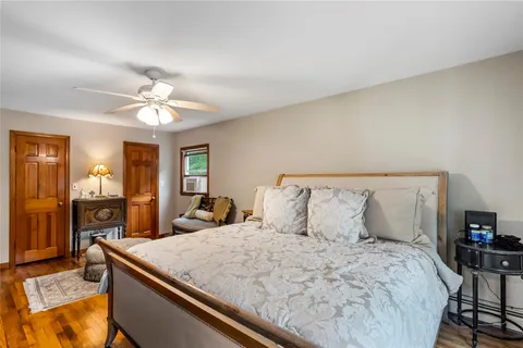 a bedroom with a large bed and a chandelier