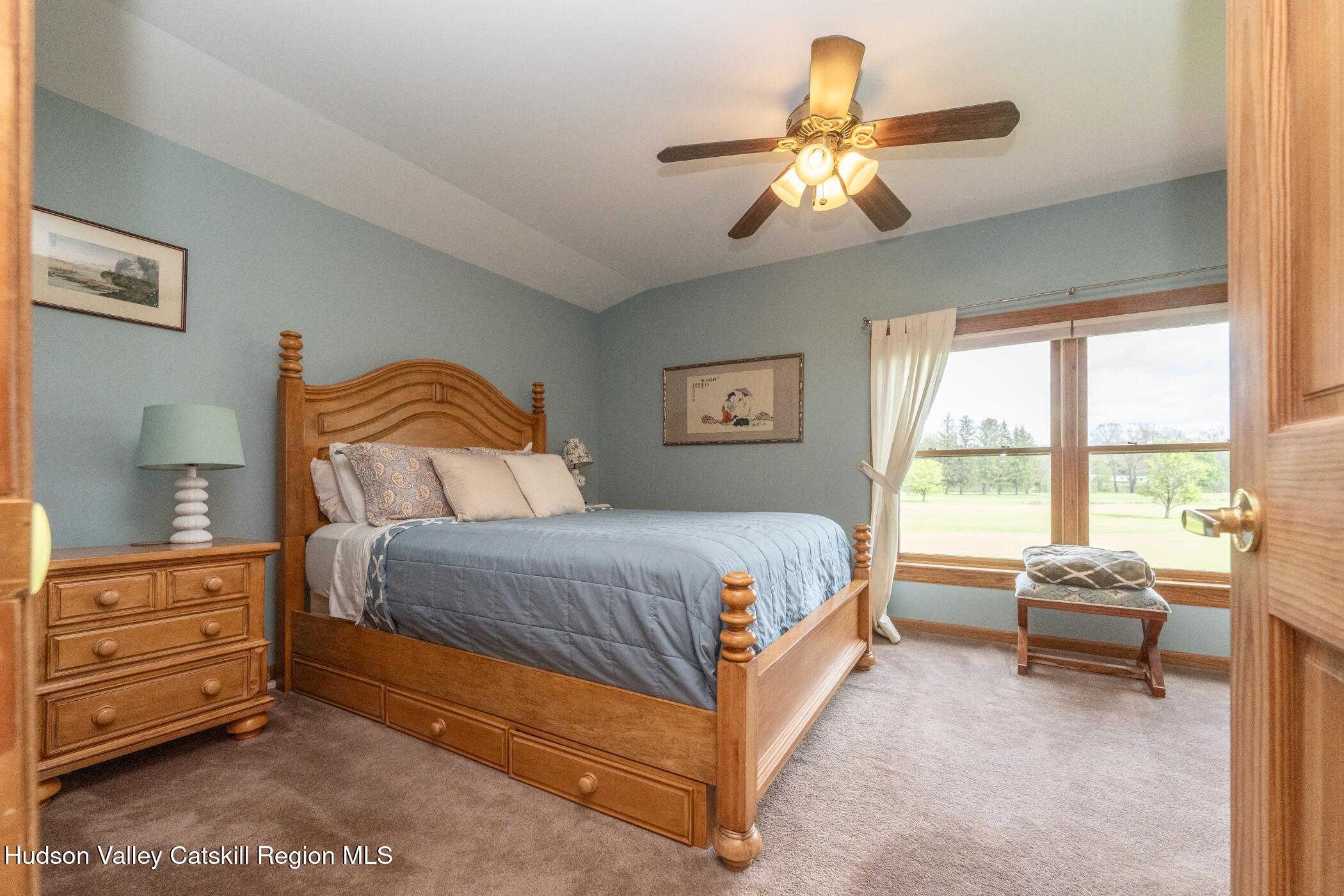 140 Stone Dock Road High Falls, NY 12440 - Photo 21 of 42 a bedroom with a bed and a chandelier