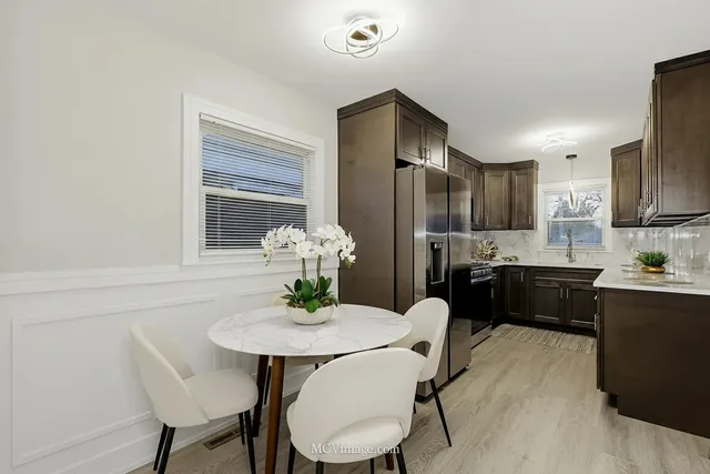 a kitchen with granite countertop stainless steel appliances a sink cabinets and a counter top space