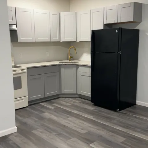 a kitchen with a refrigerator and cabinets