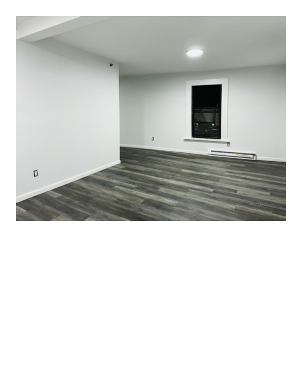 63 Water Street, Unit 22 Torrington, CT 06790 - Photo 3 of 6 a view of an empty room with wooden floor and a window