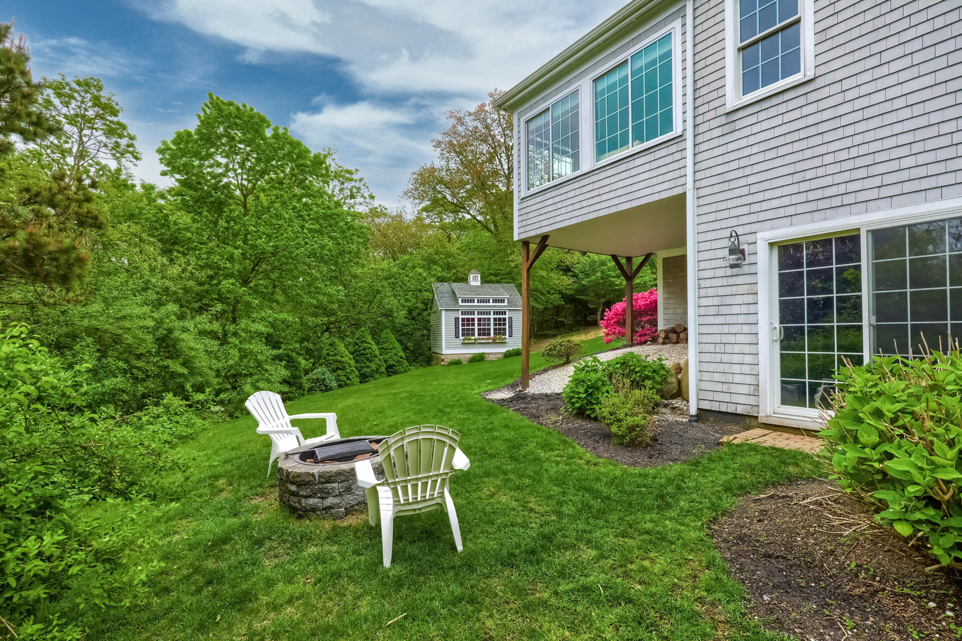 140 Great Marsh Road West Barnstable, MA 02668 - Photo 38 of 46 a view of a chair and table in the back yard of the house