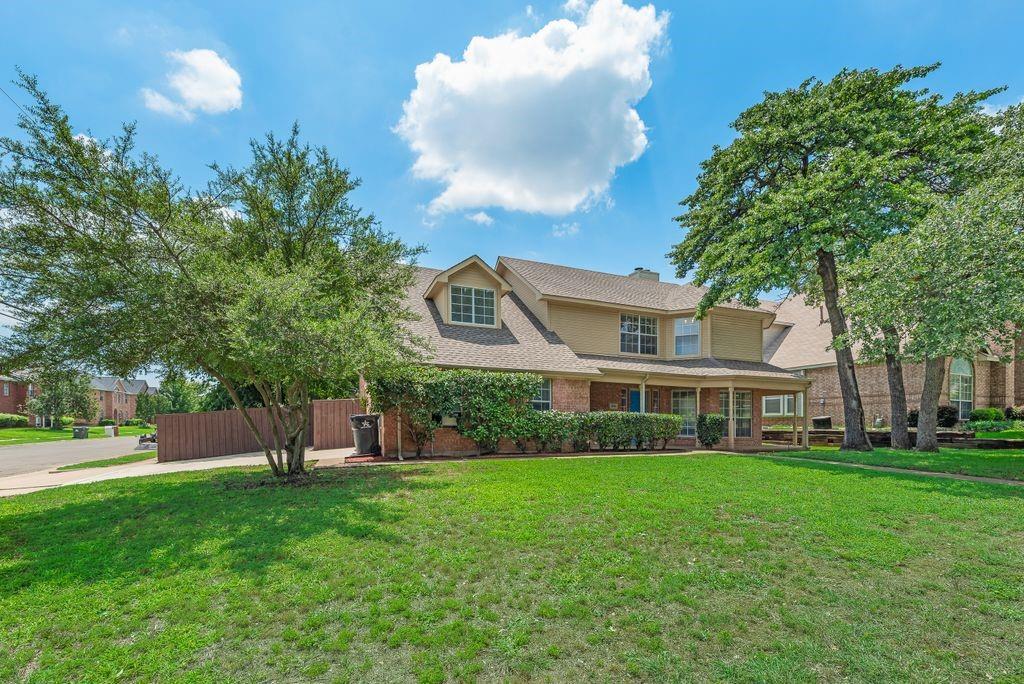 5610 Eagle Rock Road Arlington, TX 76017 - Photo 3 of 33 Traditional-style home featuring a brick and stucco exterior, dormer windows, and a covered porch