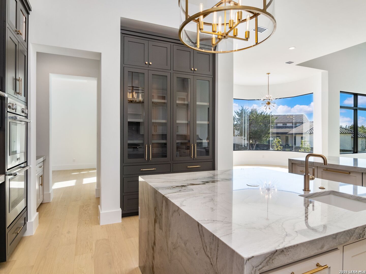 30 Paseo Rioja San Antonio, TX 78257 - Photo 18 of 70 a kitchen with a sink a counter and a large mirror
