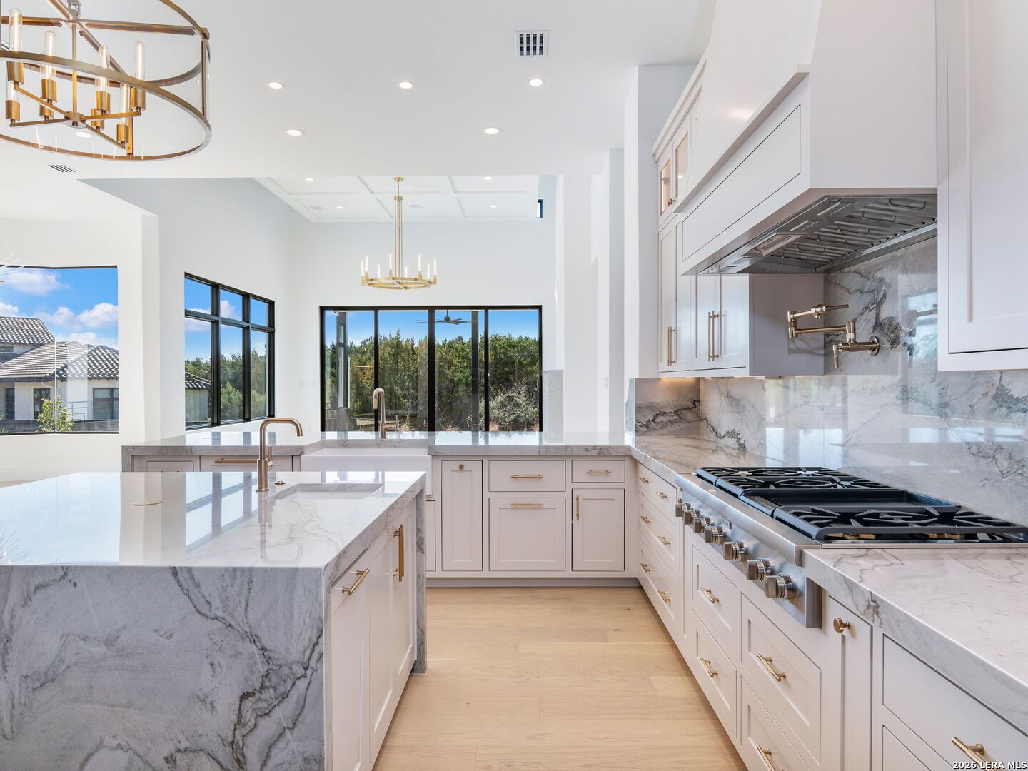 30 Paseo Rioja San Antonio, TX 78257 - Photo 19 of 70 a large white kitchen with granite countertop a stove and a sink