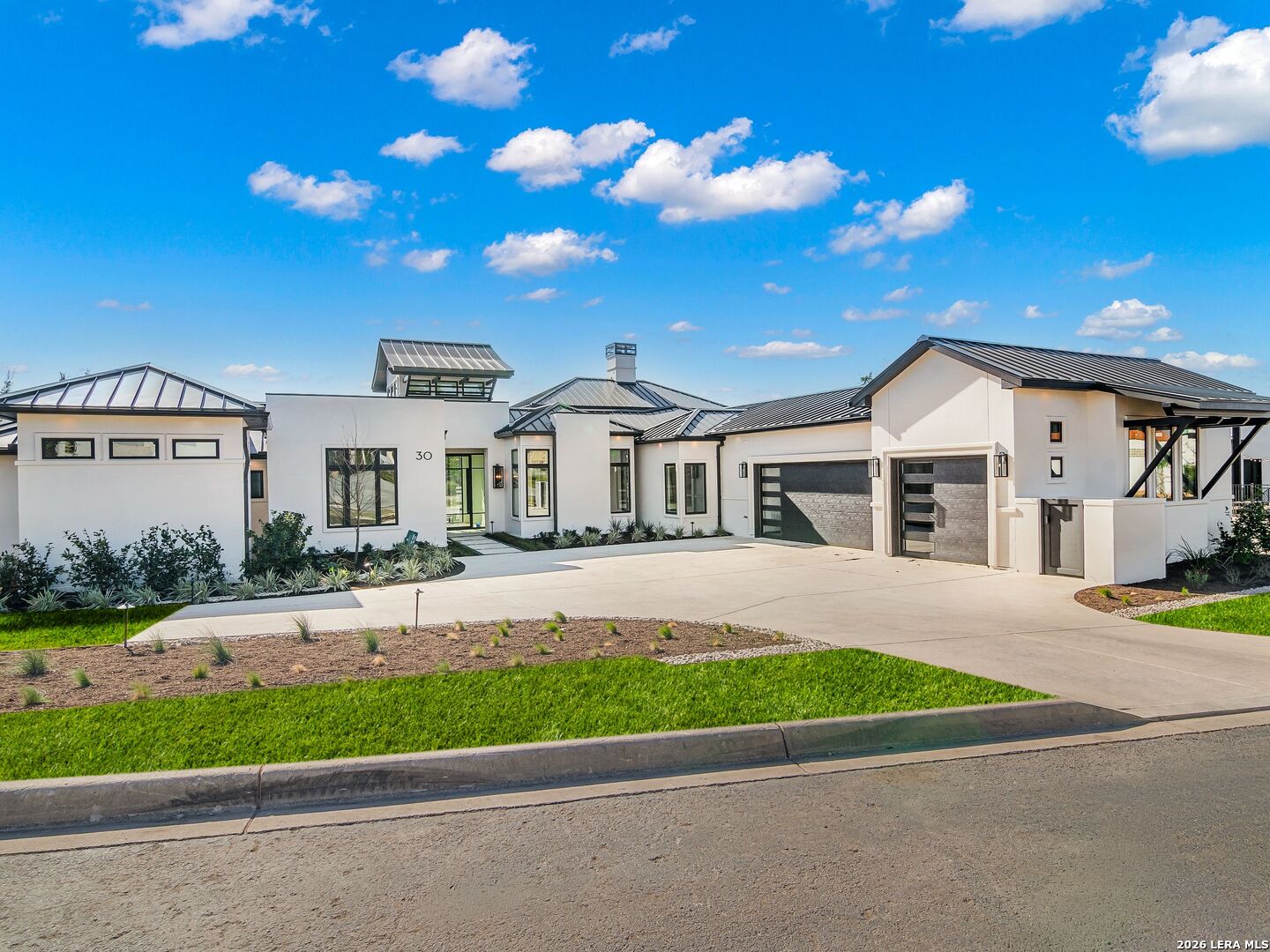 30 Paseo Rioja San Antonio, TX 78257 - Photo 2 of 70 a front view of a house with a garden and yard