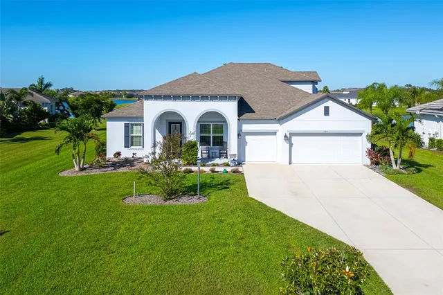 a front view of a house with a garden and plants