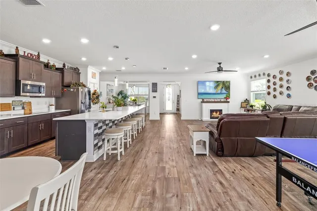 a view of a hallway with wooden floor and furniture