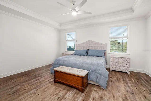 an empty room with windows and ceiling fan