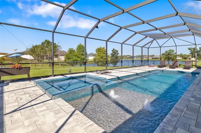 an aerial view of a house with a swimming pool yard and outdoor seating