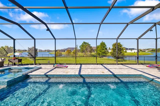 a view of a swimming pool with an outdoor space and seating area