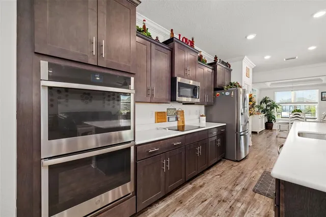 a kitchen with stainless steel appliances granite countertop sink stove and cabinets
