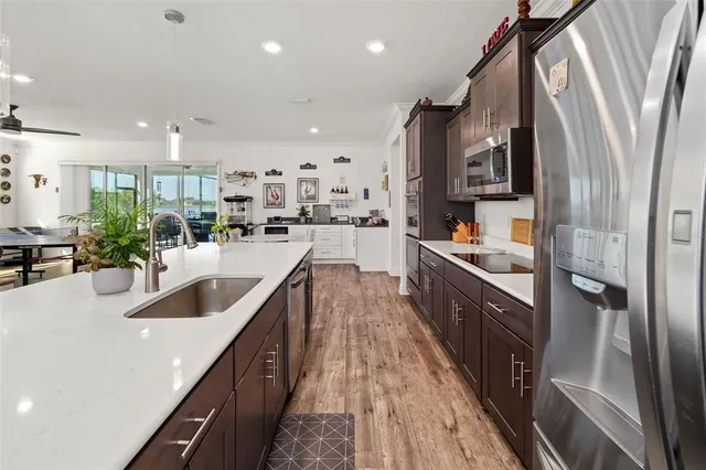 a kitchen with stainless steel appliances a sink a stove and microwave