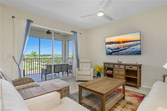 a living room with furniture and a floor to ceiling window