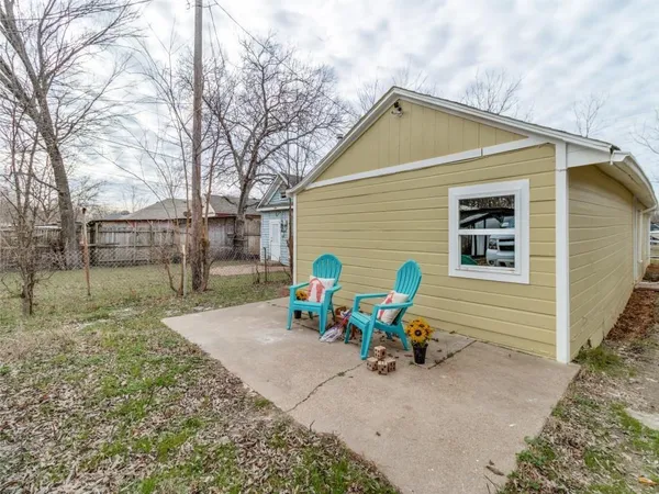 a view of backyard with outdoor seating and barbeque oven