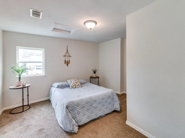 a bedroom with a bed and a table in it
