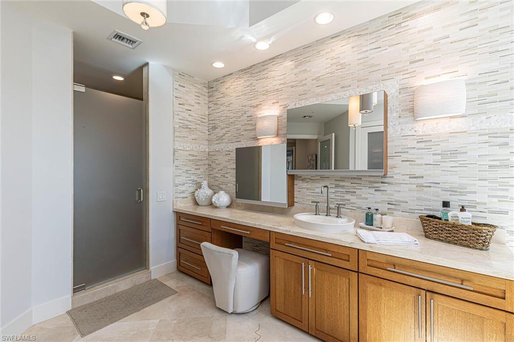 295 Grande Way, Unit PH2 Naples, FL 34110 - Photo 31 of 45 a bathroom with a sink and a mirror