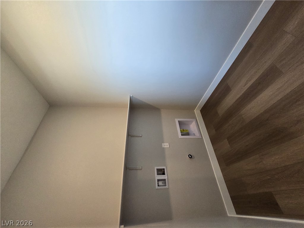 852 Weston Ridge Street Henderson, NV 89011 - Photo 21 of 28 Functional laundry space featuring convenient hookups and built-in shelving.