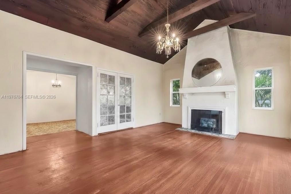 515 West 30th Street Miami Beach, FL 33140 - Photo 4 of 8 a view of an empty room with wooden floor and a fireplace