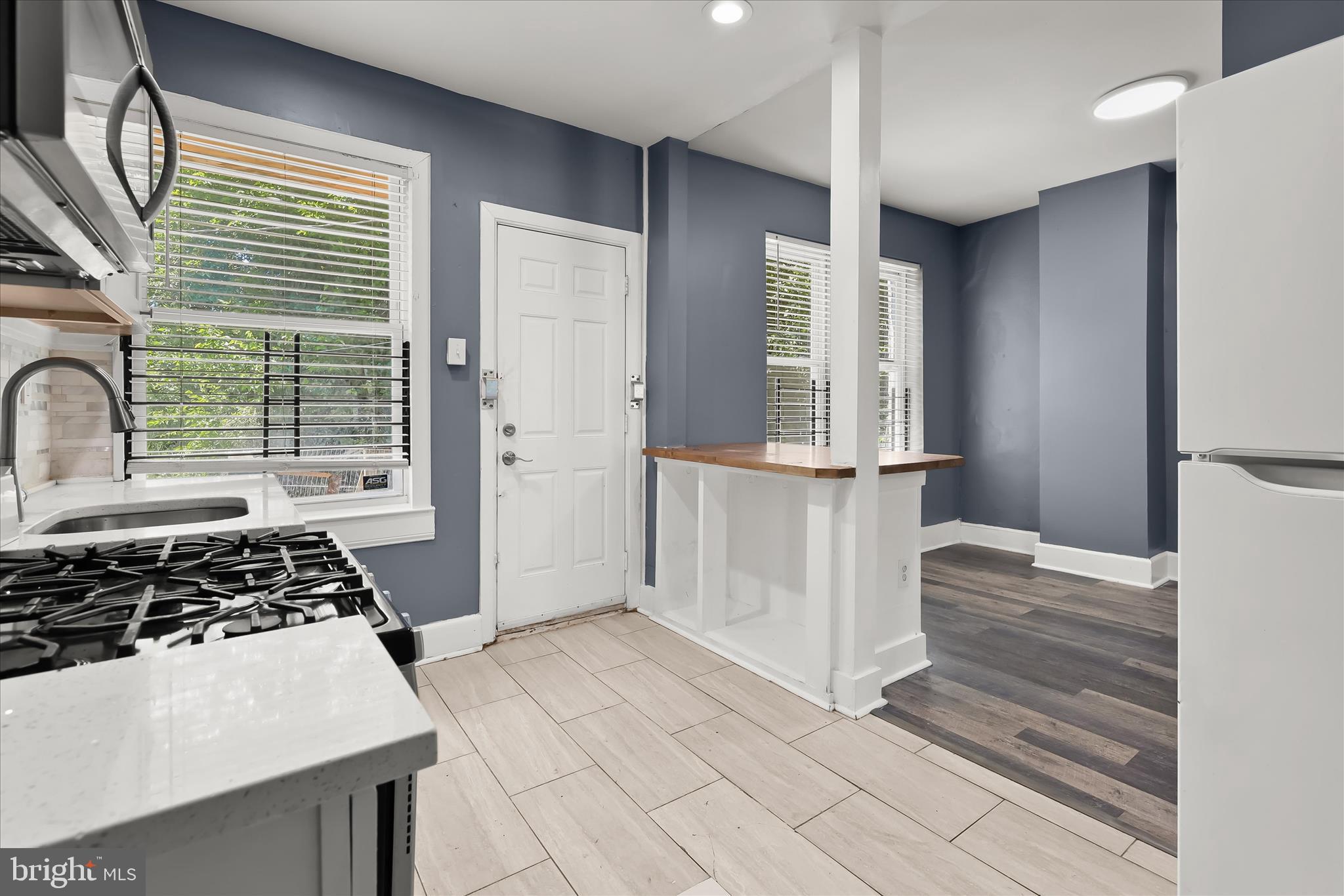 3534 Overview Road Baltimore, MD 21215 - Photo 14 of 28 a kitchen with granite countertop a stove and a refrigerator