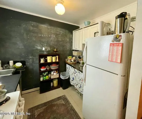 a white refrigerator freezer sitting inside of a kitchen