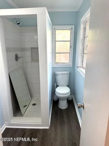 a bathroom with a toilet and a shower