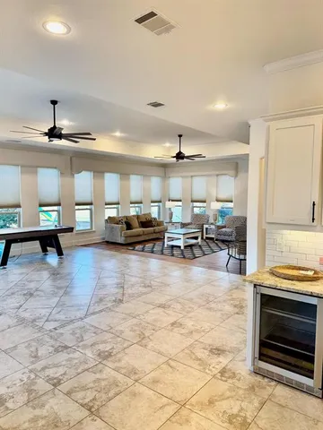 a living room with lots of furniture and kitchen view