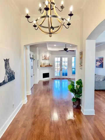 a view interior of a house wooden floor and a chandelier fan