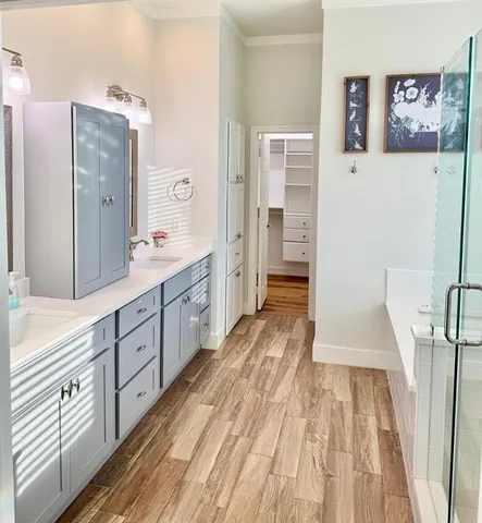 a spacious bathroom with a double vanity sink and a mirror