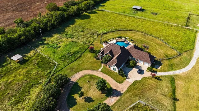 an aerial view of a house with a yard