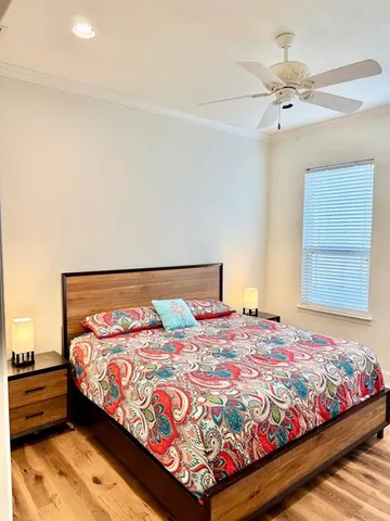 a bedroom with a bed and a chandelier