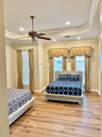 a bedroom with a bed and a chandelier