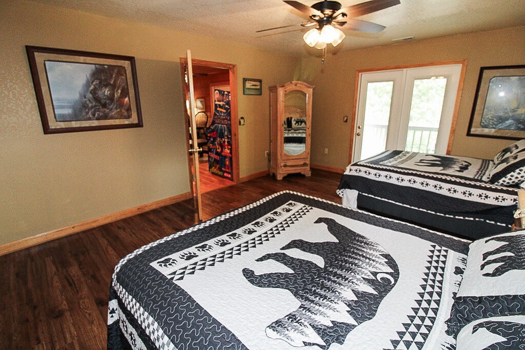 443 Loop Road Gatlinburg, TN 37738 - Photo 28 of 40 a bedroom with a bed and a chandelier
