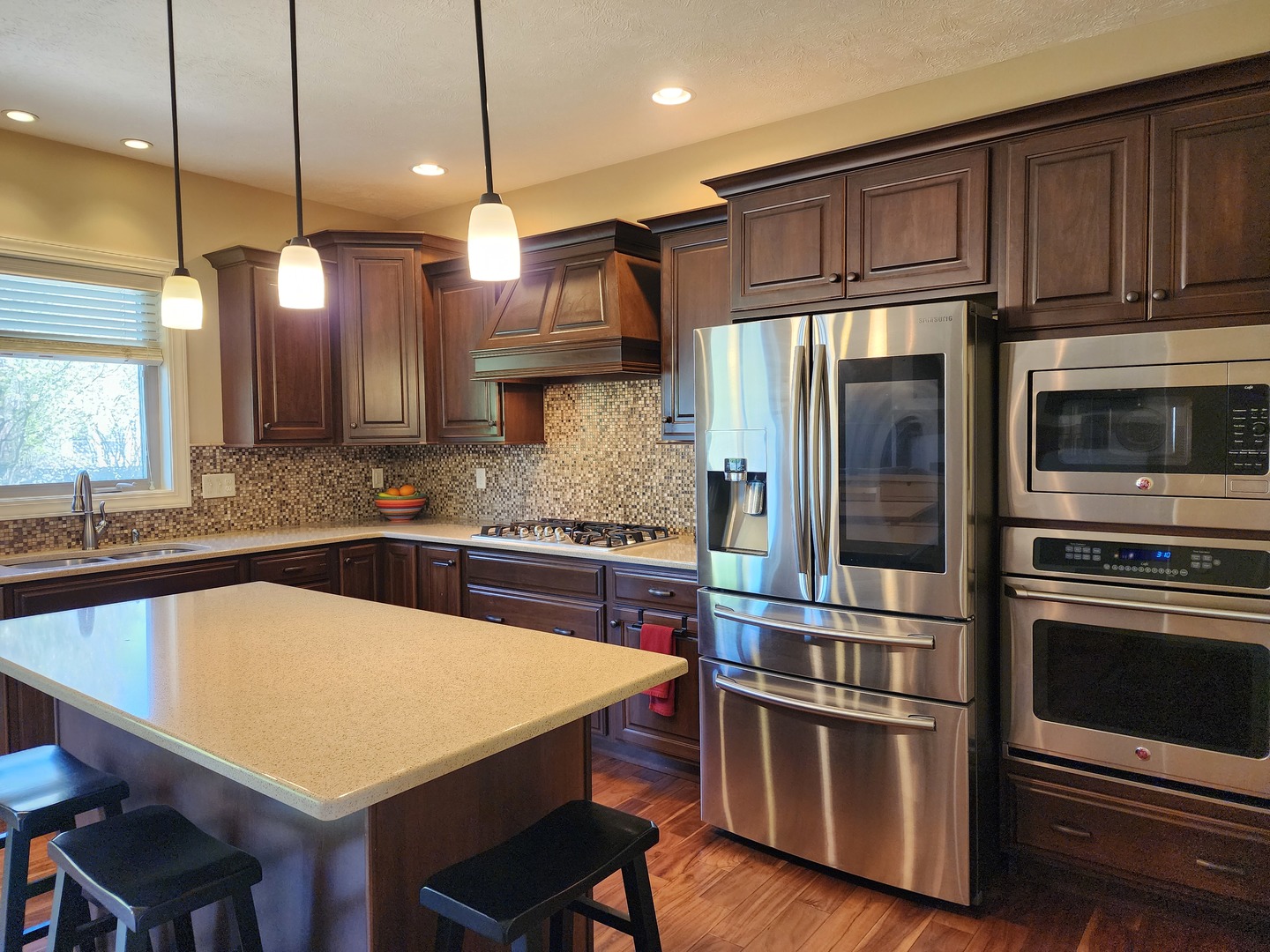 2008 Savanna Drive Champaign, IL 61822 - Photo 14 of 62 a kitchen with stainless steel appliances wooden floor sink and wooden cabinets
