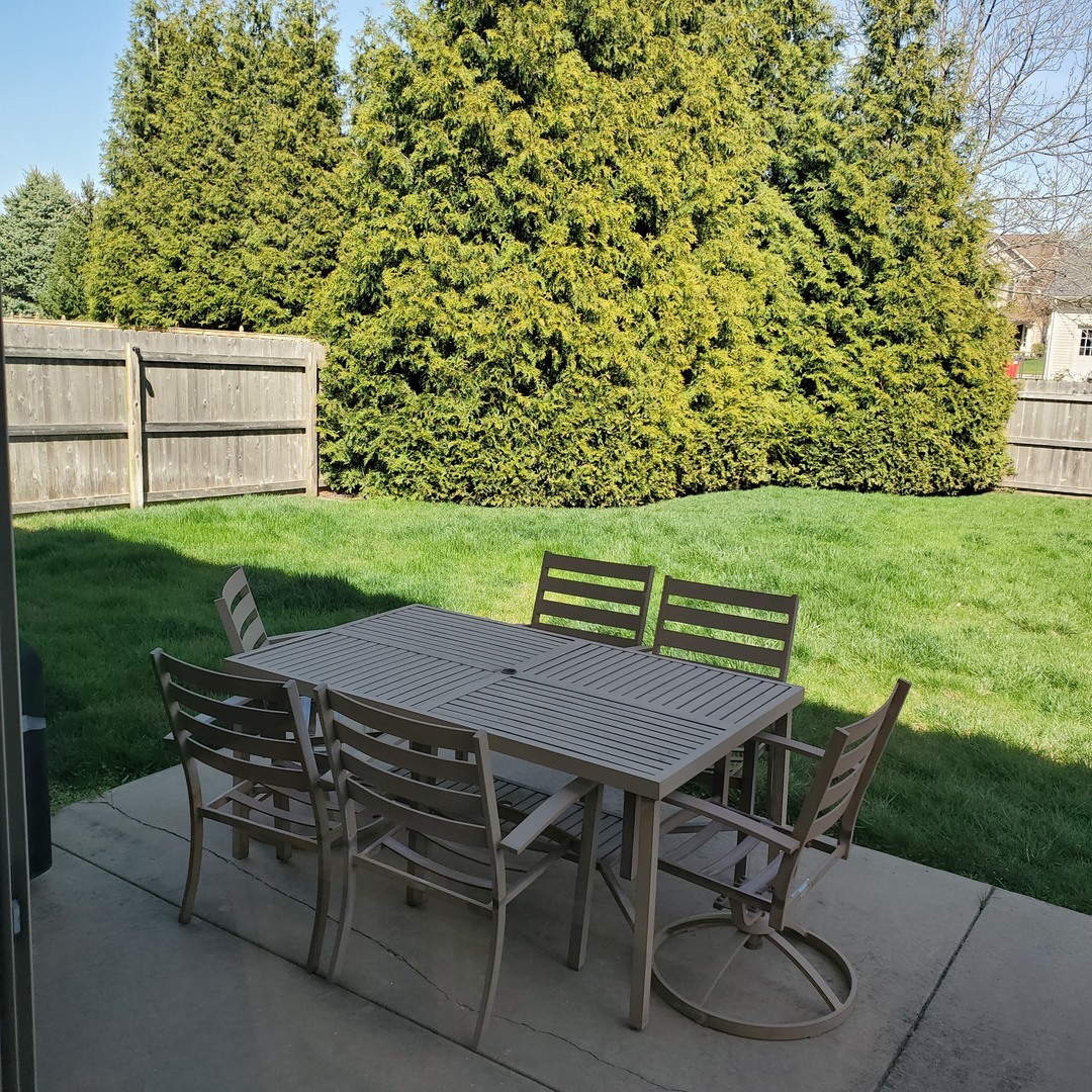 2008 Savanna Drive Champaign, IL 61822 - Photo 18 of 62 a table and chairs with the wooden floor and yard in the back