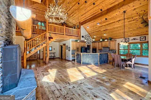 a bedroom with a bed dresser and a fireplace