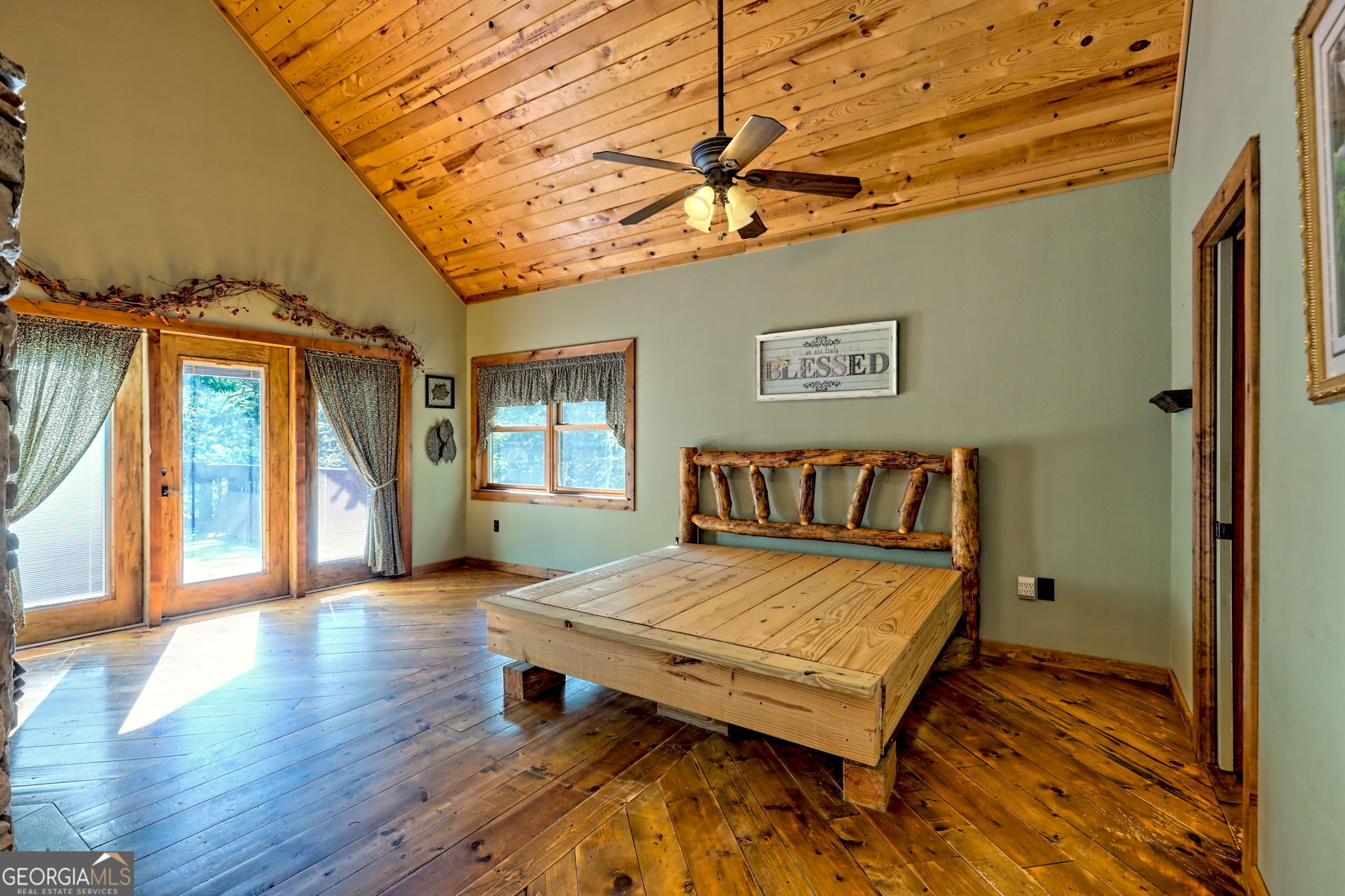 199 Camelia Lane Tiger, GA 30576 - Photo 28 of 100 a bedroom with a bed and wooden floor