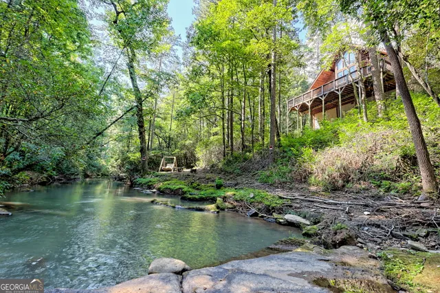 a view of a house with backyard porch and seating space