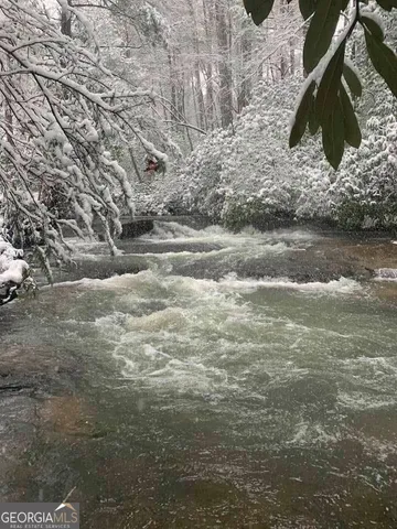 a view of a hallway with wooden floor and entryway