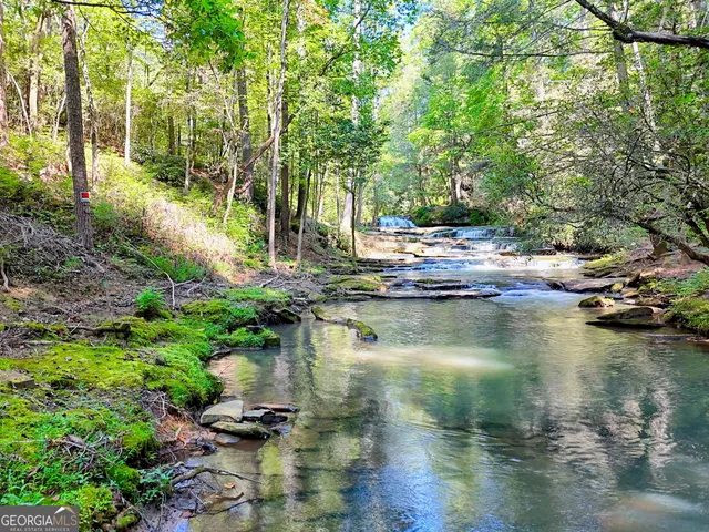 a view of a patio with couches chairs and wooden floor