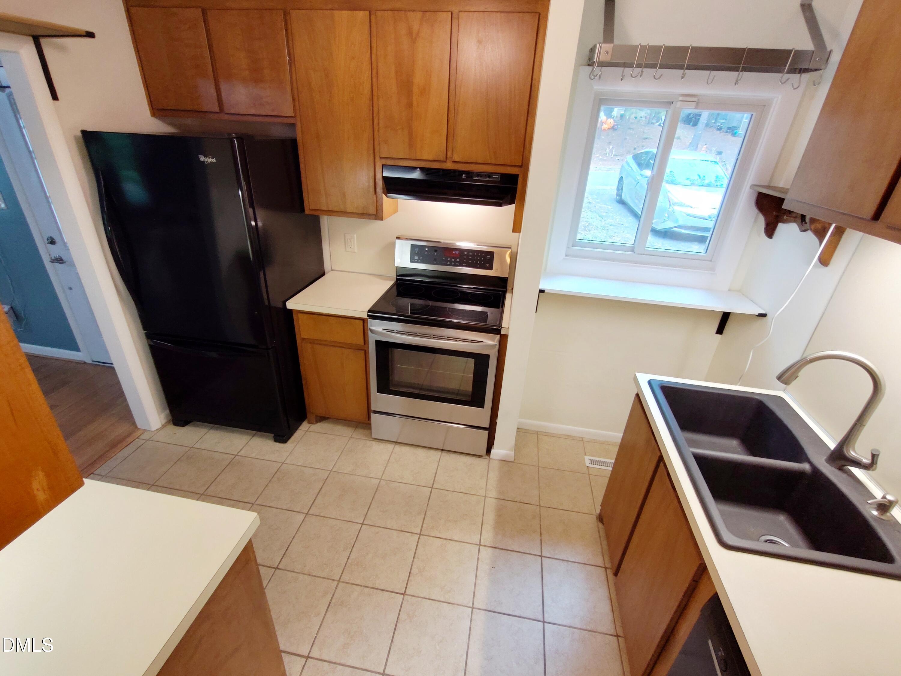 1321 Valley Run Durham, NC 27707 - Photo 5 of 19 a kitchen with a refrigerator stove and cabinets