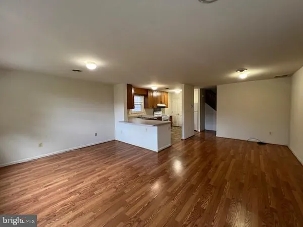 a view of a kitchen with a sink and a refrigerator