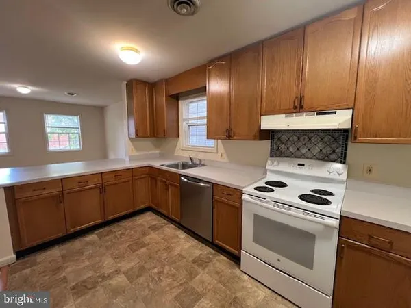 a kitchen with sink cabinets and window
