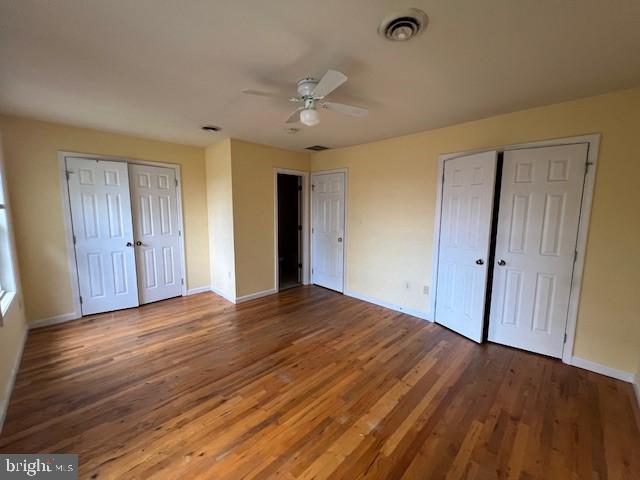 309 East 3rd Street, Unit B Frederick, MD 21701 - Photo 9 of 15 a view of an empty room with wooden floor and a ceiling fan